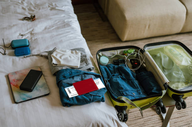 istock Packing suitcase for travel vacation at home 1391452036