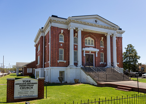 York, SC, USA-10 April 2022: York Associate Reformed Presbyterian Church, building and monument sign, sunny, blue sky spring day.