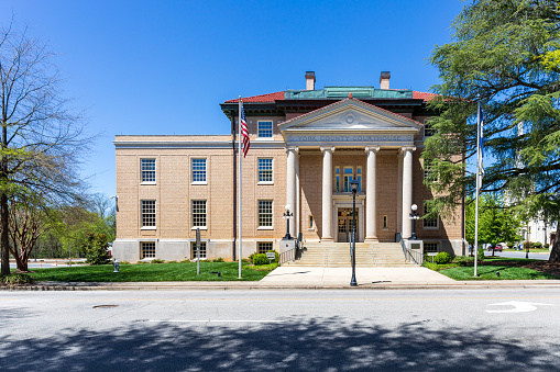 York, SC, USA-10 April 2022: The 1914 York County Courthouse, Classical Revival style.  Balanced façade, blue sky in spring .
