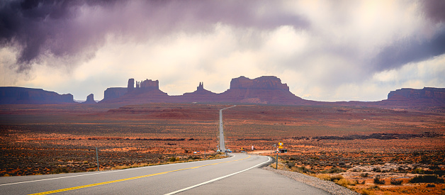 A Windy and rainy day at Monument Valley. Long road leading into Monument Valley National Park near the Navajo Nation.