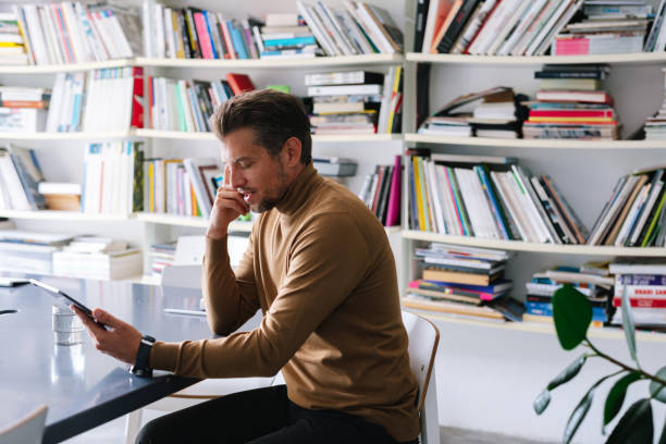 istock Man Reading On The Tablet In The Office 1391456833