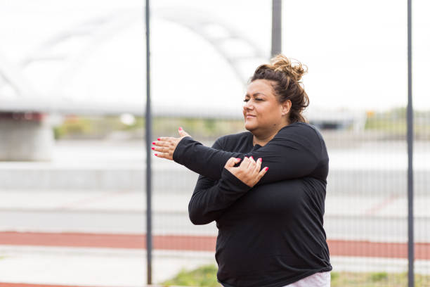 istock Beautiful plus size Hispanic Latin woman doing stretch exercises 1391456902