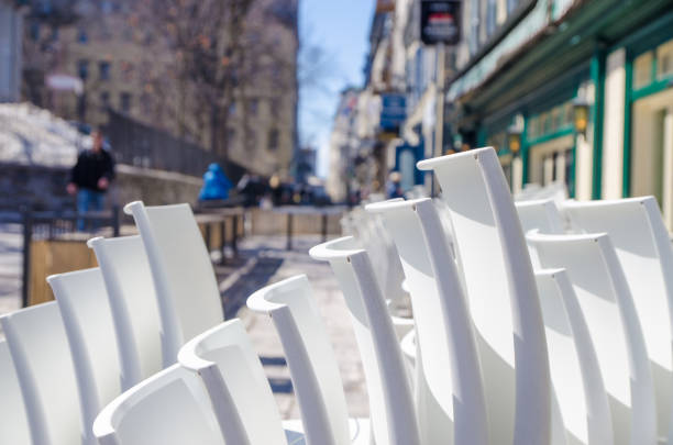 istock Pile of white chairs on restaurant patio 1391457210