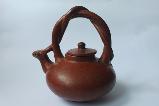 old clay teapot on white background