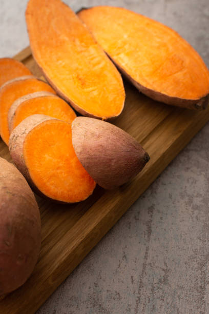 istock Whole and cut raw orange sweet potato 1391459396