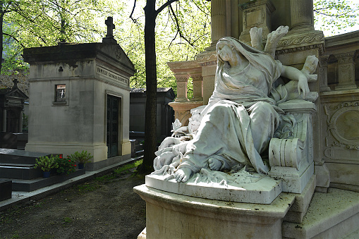 Paris, France-04 14 2022: Statue and mausoleums in the Montparnasse cemetery, Paris, France.