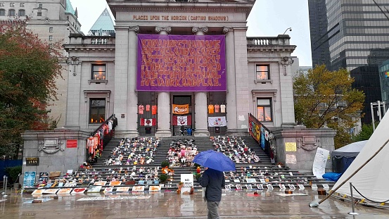 Scene Of Vancouver Art Gallery In British Columbia Canada, People, Children's Boots And Shoes On The Ground As A Memorial For All The Dead first Nations Children