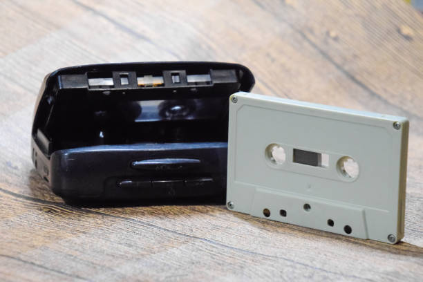 istock Retro audio cassettes next to a portable player to play compact cassettes. 1391462611
