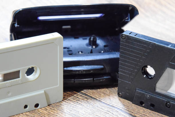 istock Retro audio cassettes next to a portable player to play compact cassettes. 1391462614