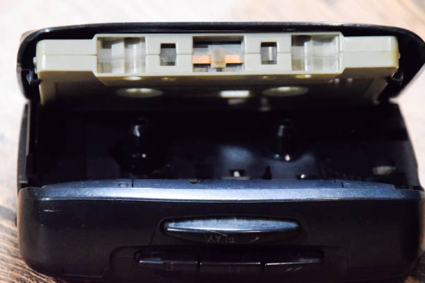 istock Retro audio cassettes next to a portable player to play compact cassettes. 1391462616