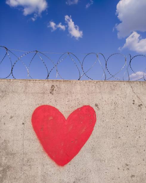 istock red heart on the wall with barbed wire 1391462899