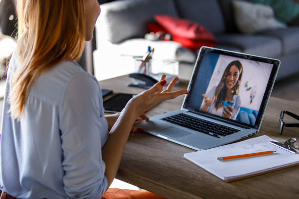 istock Young woman gesturing while video chatting with a friend 1391464020