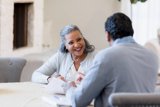 istock Senior woman meets with financial advisor 1391464028