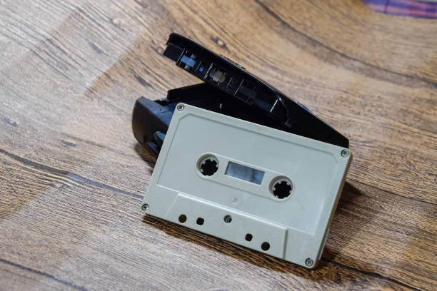 istock Retro audio cassettes next to a portable player to play compact cassettes. 1391464611