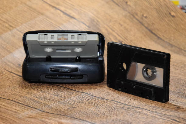 istock Retro audio cassettes next to a portable player to play compact cassettes. 1391464614