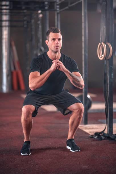 istock Focused Caucasian Male Athlete doing Squats at Gym 1391465425