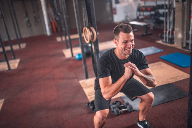 istock Focused Caucasian Male Athlete doing Squats at Gym 1391465431