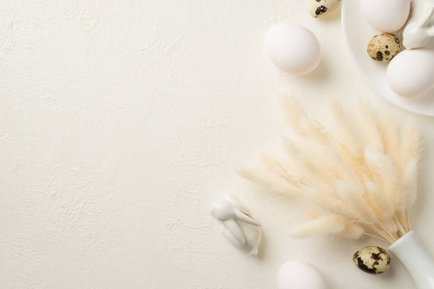 istock Top view photo of easter decorations white vase with lagurus flowers plate two ceramic easter bunnies and eggs on isolated white background with copyspace 1391465949