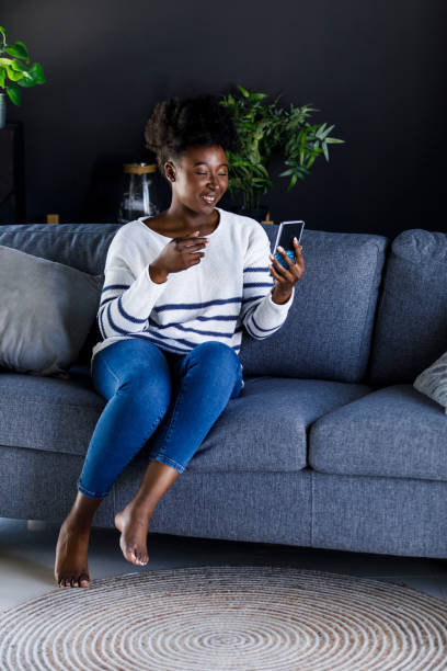 istock Joyful young woman gesturing while video conferencing with a friend 1391467945