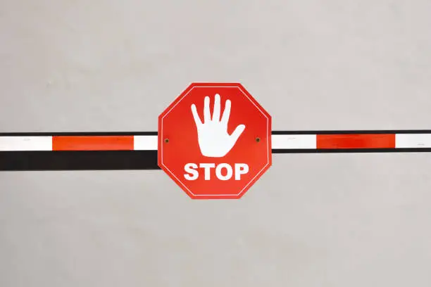 Stop sign on a red-white barrier. There is no road, the passage is prohibited. Prohibition sign.