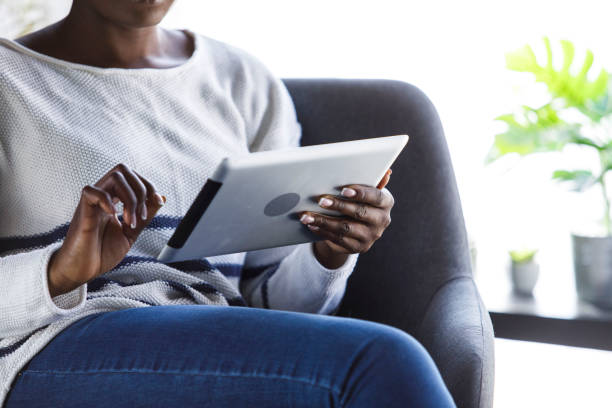 istock Copy space shot of unrecognizable woman using digital tablet 1391468190
