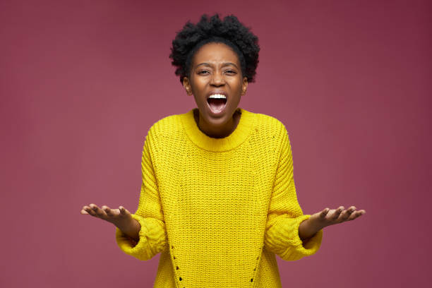 Excited irritated expressive african american young woman spreading hands scream in furious. Emotional quarrel Excited irritated expressive african american young woman spreading hands scream in furious. Emotional quarrel. High quality photo gloomy mood stock pictures, royalty-free photos & images