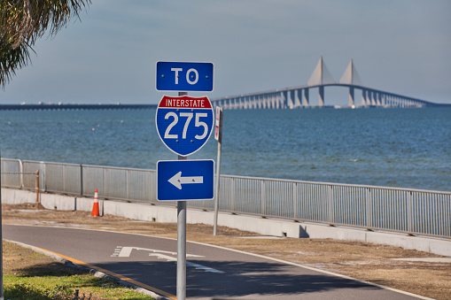 Selective focus of an Interstate 275 sign with the Sunshine Skyway Bridge in the background.