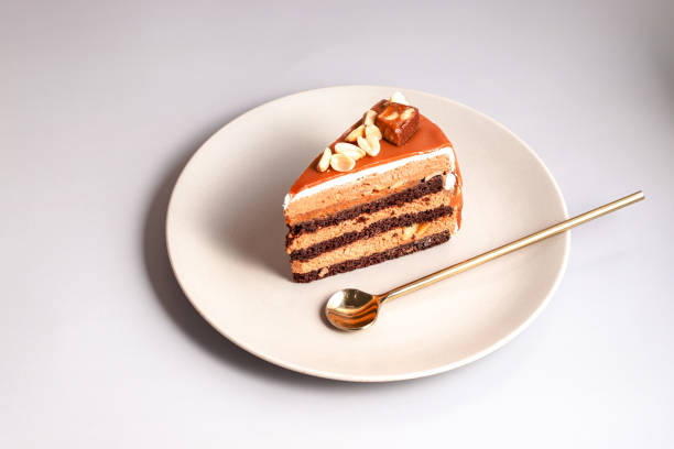 istock caramel cake decorated peanuts served on beige plate on beige background. close up with copy space 1391472051
