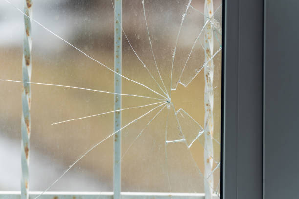 istock Glass broken by hooligans in a metal-plastic window, close-up 1391474235