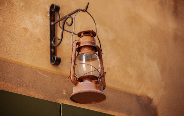 Rusted streetlight on white wall