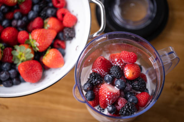 istock pouring milk into the blender for berry smoothie 1391475747