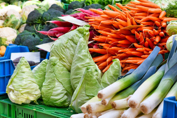istock Vegetables like pointed cabbage and carrots at market 1391480029