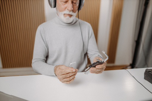 Retired man using his smartphone for vlogging