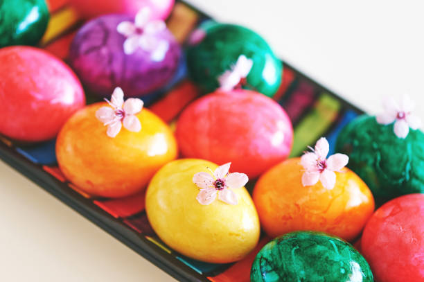 istock Colorful easter rggs on a plate with tender spring flowers 1391495309