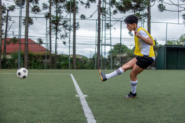 istock Female player kicking ball 1391495355