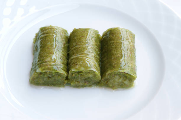 istock Turkish  Baklava  ( Fıstık Sarma Baklava ) stuffed with green pistachio nuts wrapping. 1391496223
