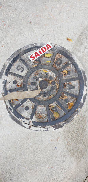 istock Manhole cover on the street 1391496319