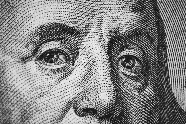 istock Hundred dollar bill macro texture, Franklin eyes closeup 1391499339