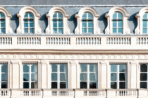 Facade of a beautiful old tenement house in France, historic French architecture.