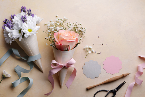 Cute  party bouquets with paper cones and ribbons.