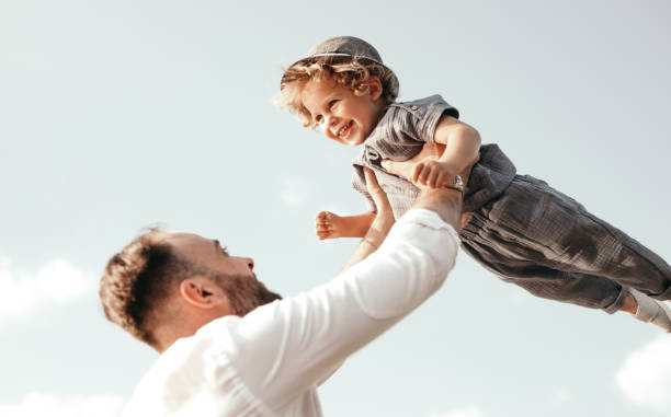 istock Happy father tossing little son 1391504785