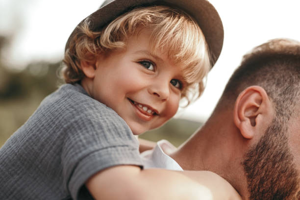 istock Cheerful boy riding back of father 1391504789