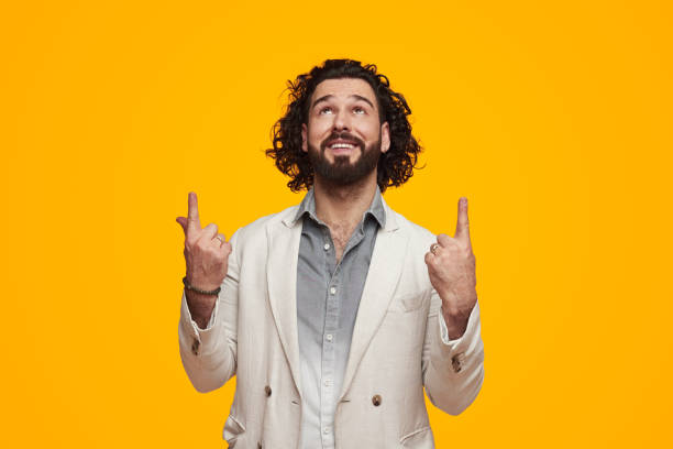 istock Happy stylish man pointing up in studio 1391504858