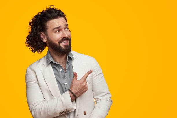 istock Happy bearded male pointing at empty space 1391504871