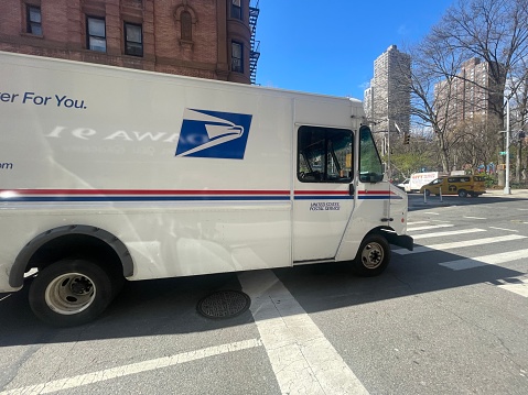 New York, NY  USA - April 15, 2022: New York City, US Mail Truck on New York City Street Corner