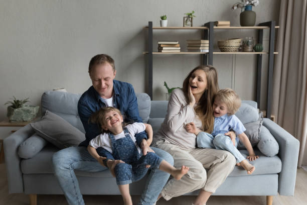 istock Happy young parents playing with small children. 1391505458