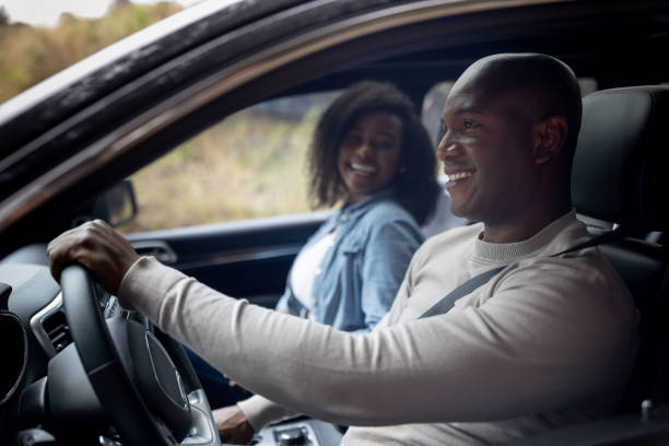 istock Happy couple going on a road trip in their car 1391517612