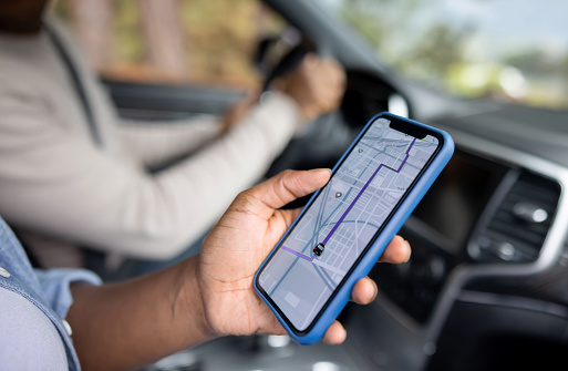 Close-up on a couple using the GPS while driving a car