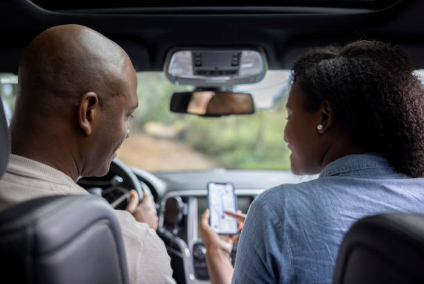 istock Couple going on a road trip in their car and using the GPS 1391517623
