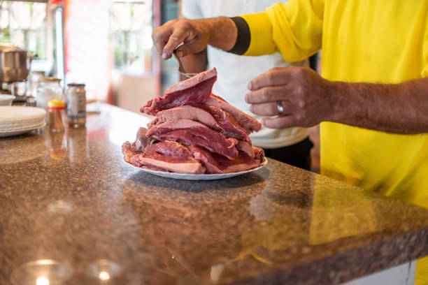 A plate with sliced meat and sauce on a festive table.